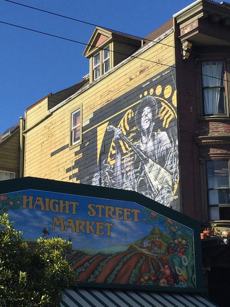 A portrait of Jimi Hendrix on the side of his former home