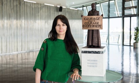 Gillian Wearing in front of a maquette of her Millicent Fawcett sculpture