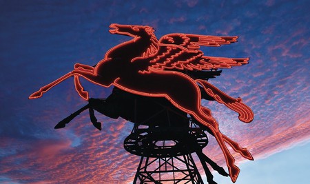 The neon red Pegasus shines bright in front of the Omni Dallas Hotel