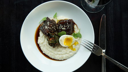Short rib served with grits, collard-green kimchi and a soft-boiled egg