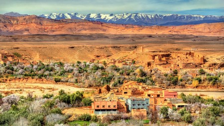 The snowy High Atlas Mountains provide a beautiful backdrop to Kalaat M’Gouna in Morocco