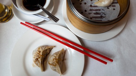 GN9F6R Steamed vegetable dumplings with soy sauce at a table in a Chinese restaurant in Chinatown in New York City