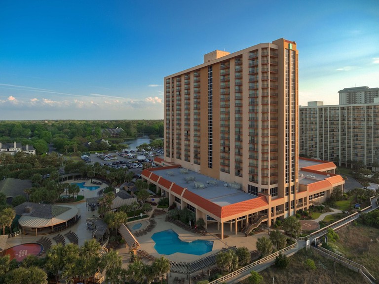 Embassy Suites by Hilton Myrtle Beach Oceanfront Resort pools with sea beyond