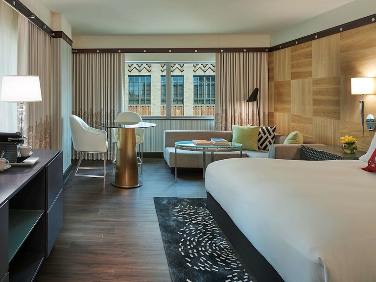 The spacious, stylish living and dining space with artwork of the presidential suite at Sofitel Philadelphia at Rittenhouse Square