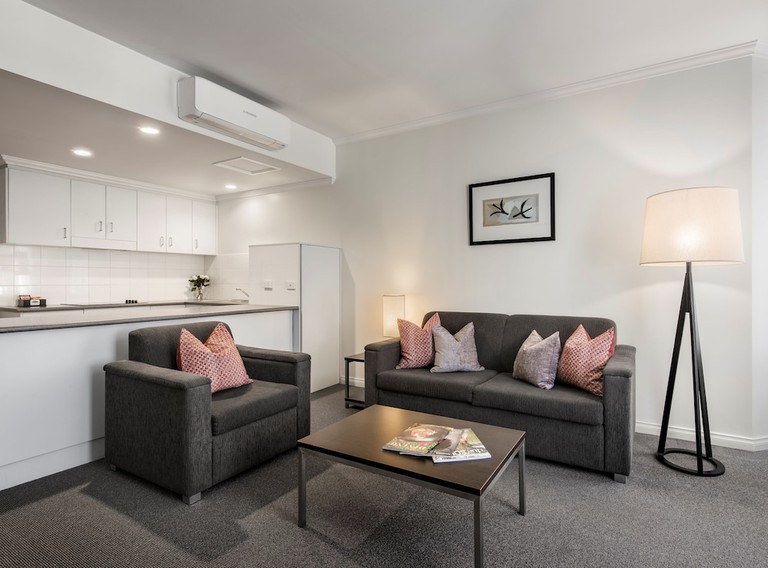 A cosy living room and light-filled kitchen at the Franklin Apartments