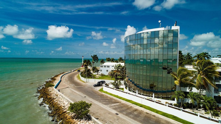 Radisson Fort George Hotel and Marina exterior with adjacent sea and palms