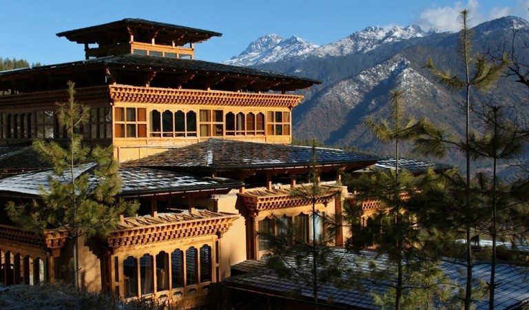 An external view of the Naksel Boutique Hotel & Spa with snow-covered mountains in the background