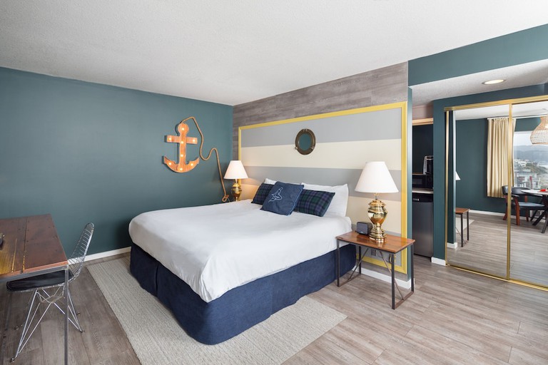 Nautical-themed guest room with two beds and kitchenette at Surftides Lincoln City