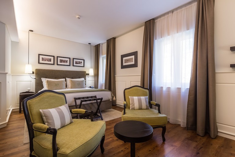 Double bedroom at Lisbon Wine Hotel with a red, white and cream colour palette