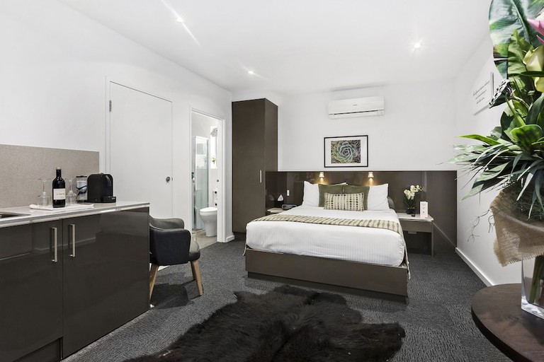 A spacious studio with two beds and a kitchenette at the North Adelaide Boutique Stays Accommodation