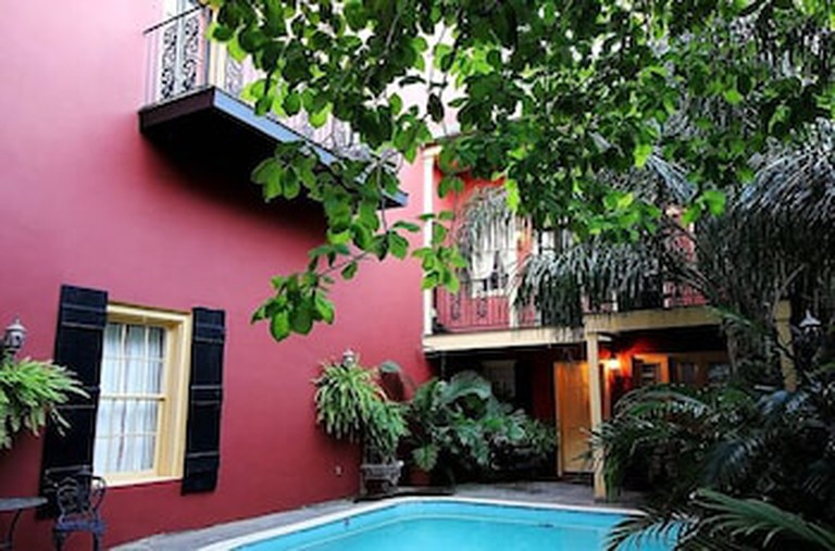 The courtyard at the Olivier House Hotel in New Orleans with plants and a table