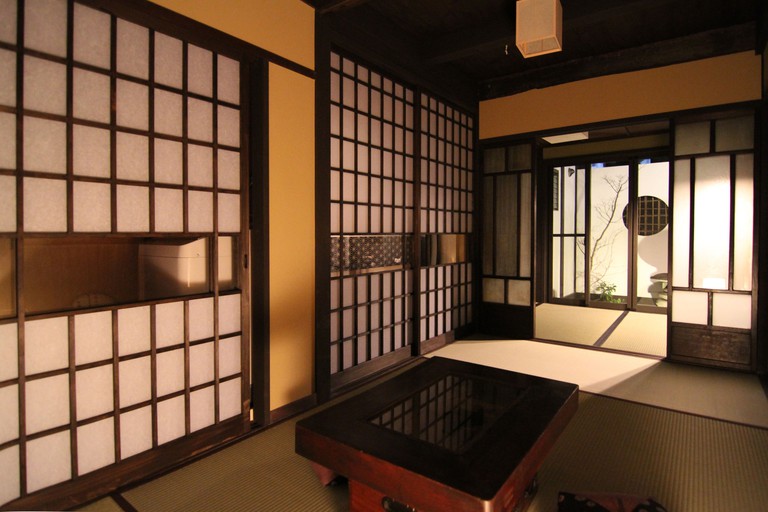 The interior of Shikokuan Machiya Residence Inn, Kyoto, featuring sliding shōji doors