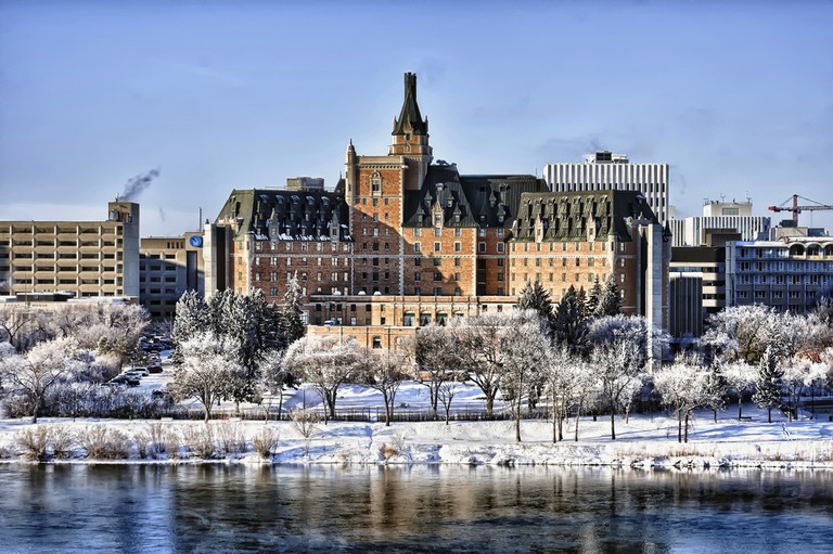 Delta Bessborough hotel in front of an icy river and snowy trees