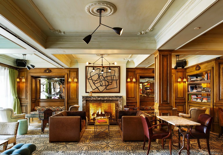 The wood-panelled lounge at The Marlton Hotel with its impressive firplace and luxurious seating arrangements.
