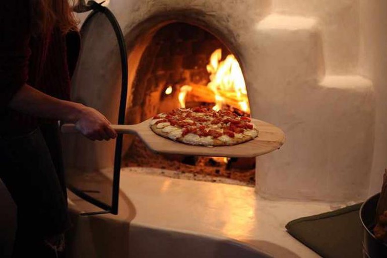 Pizza baking in Woodfired oven