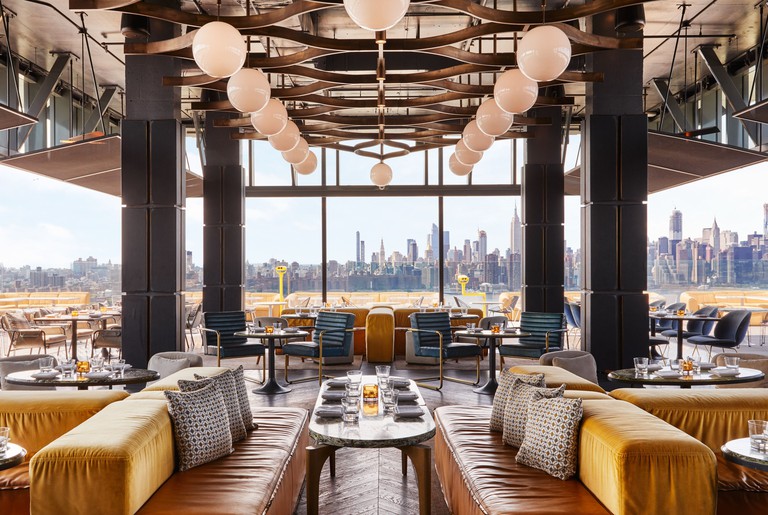 The dining room of the restaurant at the William Vale looks our over the mid-town Manhattan skyline.