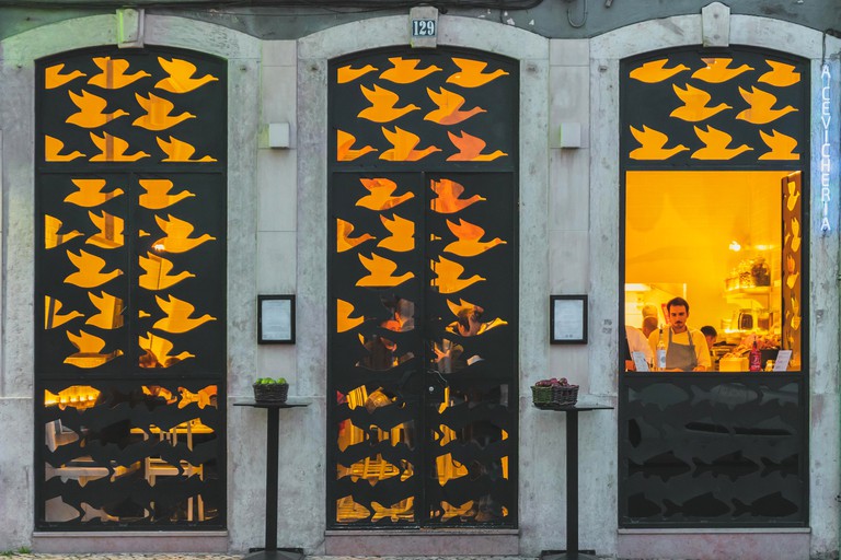 Lisbon, Portugal - 01/03/19: Store front withg metal bird cutouts, Cevicheria. Design black metallic windows and doors in a bird and fish pattern