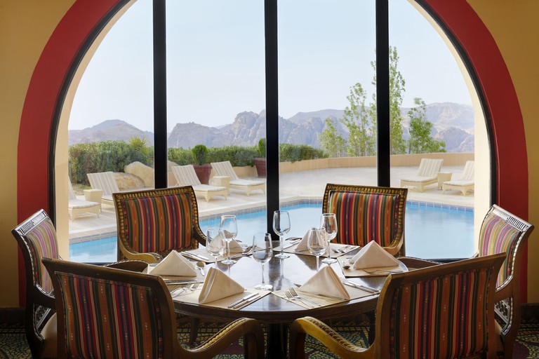 Petra Marriott Hotel restaurant with pool outside and mountain view