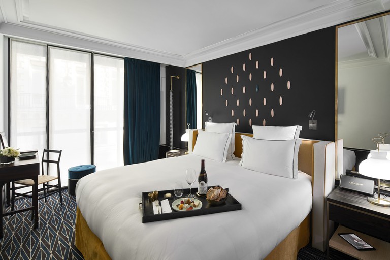 Light-filled and contemporary double room with stylish furnishings, including a desk at Le Roch Hotel and Spa in Paris.
