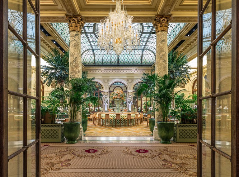 The Plaza, 5th Avenue's iconic Palm Court dining room with stained glass ceiling and marble pillars.