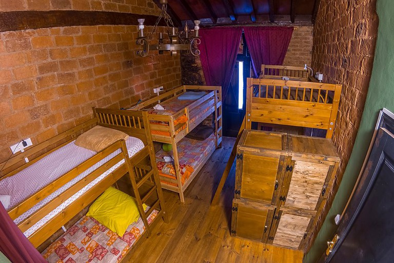 Three bunkbeds in room with brick walls at B&B La Laguna, Tenerife