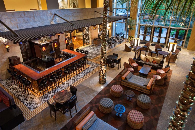 A birds' eye view of the lobby and bar area at Hotel Contessa decorated in a Spanish style