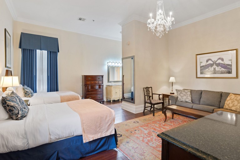 A twin room with large sofa and simple decorations at Andrew Jackson Hotel®, a French Quarter Inns® Hotel