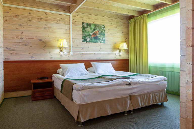 Wooden room at Baikal View Hotel with butterfly photo on wall
