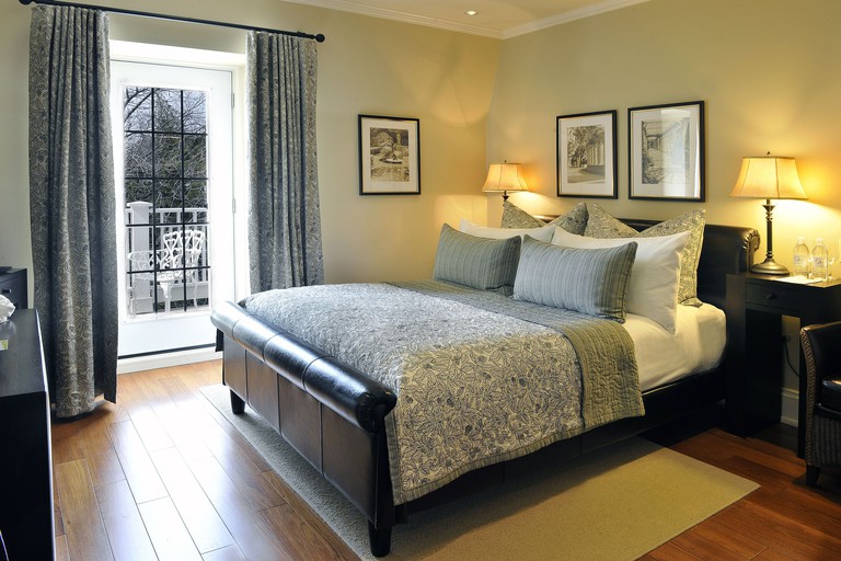 A double at the Oban Inn with a balcony, floral bedspread, leather headboard and wood floors