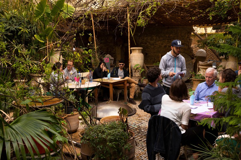 Morocco, Fes, Fes el Bali, Medina, Ruined Garden restaurant customers at outdoor tables