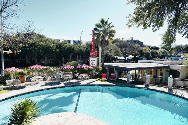 Austin Motel has the best swimming pool in town, with red and white umbrellas and deckchairs