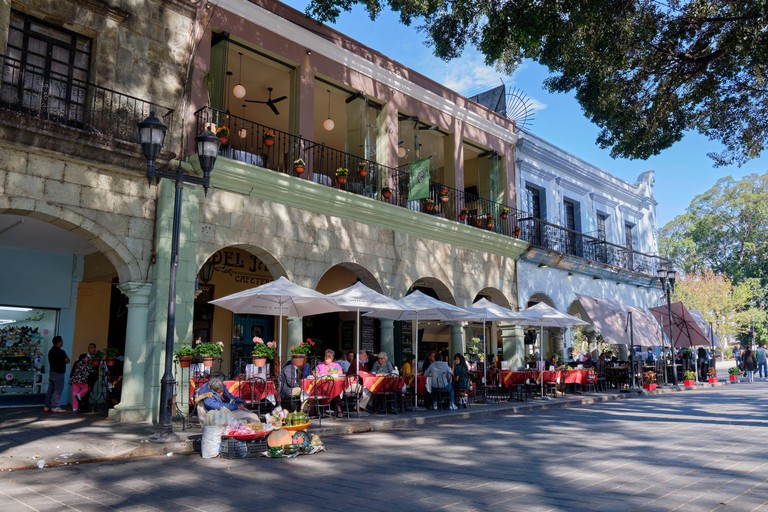 Outdoors cafe and patio restaurant, in colonial architecture, on the centre square of Oaxaca, Mexico.