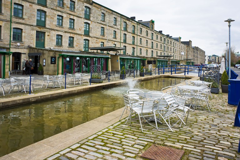 Commercial Quay in Leith with restaurants, shops and cafes along the street with The Kitchin far left.