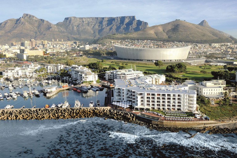 The Radisson Blu Waterfront by a harbour with Cape Town Stadium behind