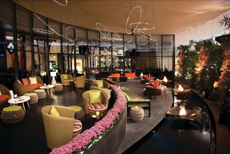 Vdara Hotel and Spa lobby lounge with water feature and trees, flowers