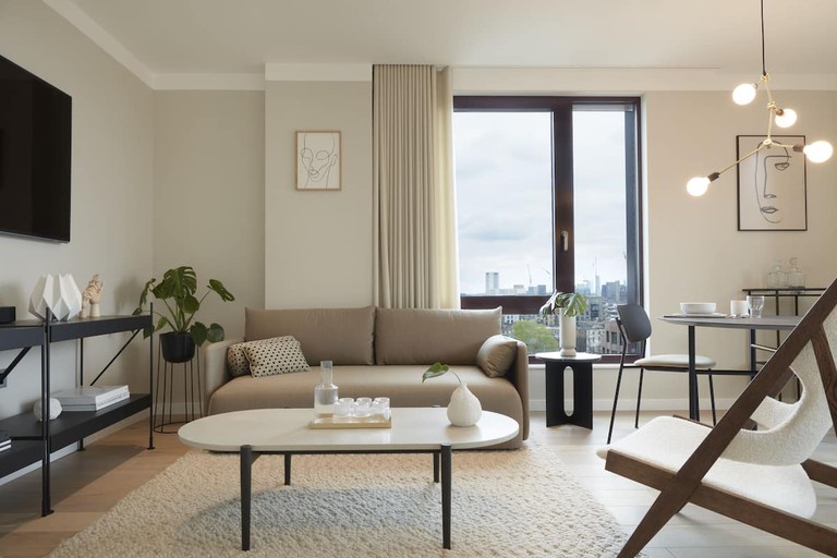 An apartment with modern furniture and decor in a neutral colour palette at STAY Camden.