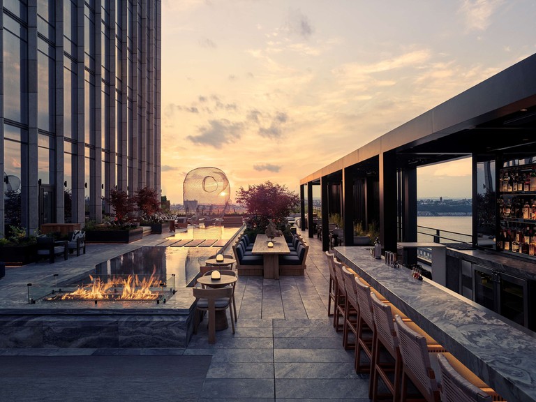 The rooftop with fireplaces and a bar at the Equinox Hotel New York