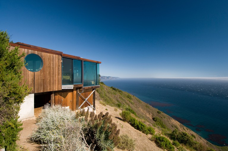 Post Ranch Inn made up of wooden containers on top of the hillside with ocean views, Big Sur California