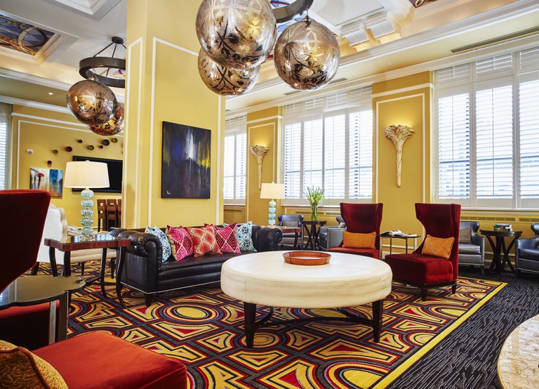 Large communal room at Kimpton Hotel Monaco Salt Lake City, boldly decorated in yellows, reds and browns