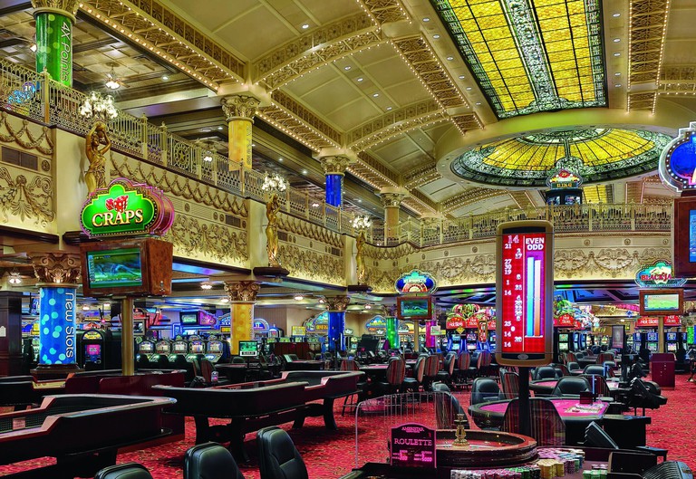 Casino at Ameristar Casino, with a stained glass ceiling, elaborate gold moulding and multiple roulette tables, jackpot machines and blackjack tables