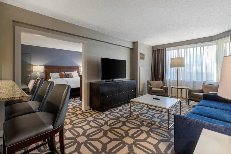A spacious one-bedroom suite with a cozy living room at the Omni Richmond Hotel