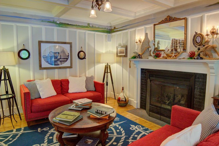 Nonantum Resort lounge with nautical rum and fireplace with sailing ornaments on mantelpiece