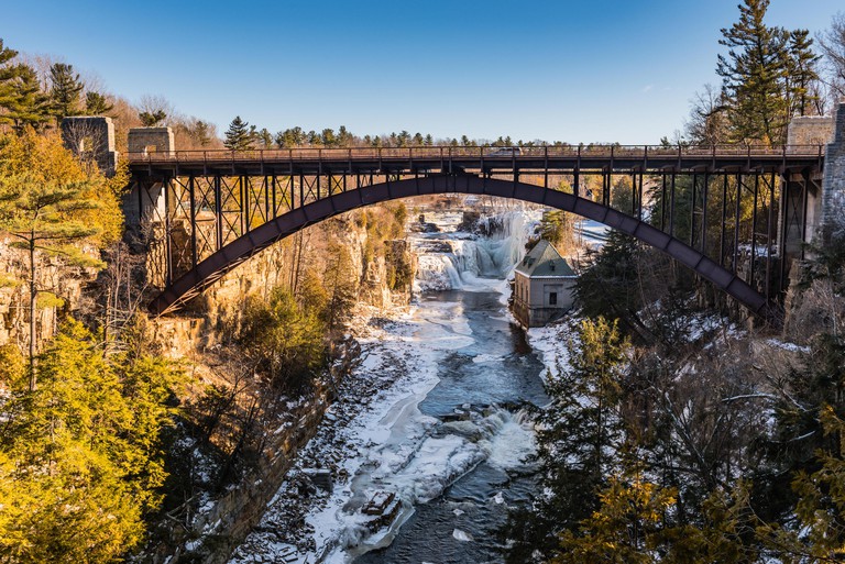 Iron bridge over Ausable River at Ausable Chasm, a 2 mile gorge in the Adirondacks of Upstate New York known as the Grand Canyon of the East.