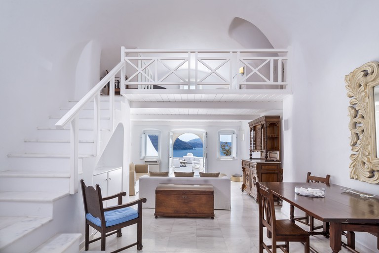 A luxurious cave suite with private terrace and mezzanine sleeping level at Canaves Oia Boutique Hotel