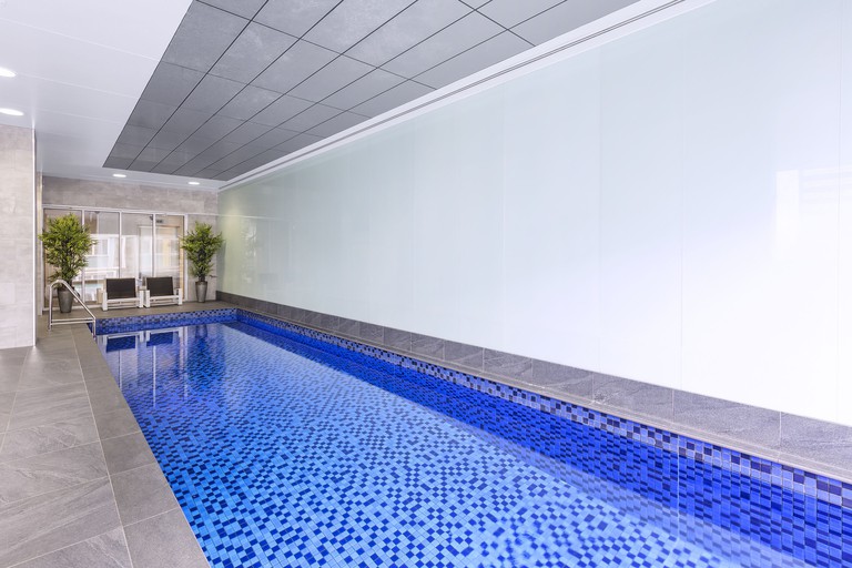 The blue-tiled indoor lap pool at the iStay Precinct Adelaide