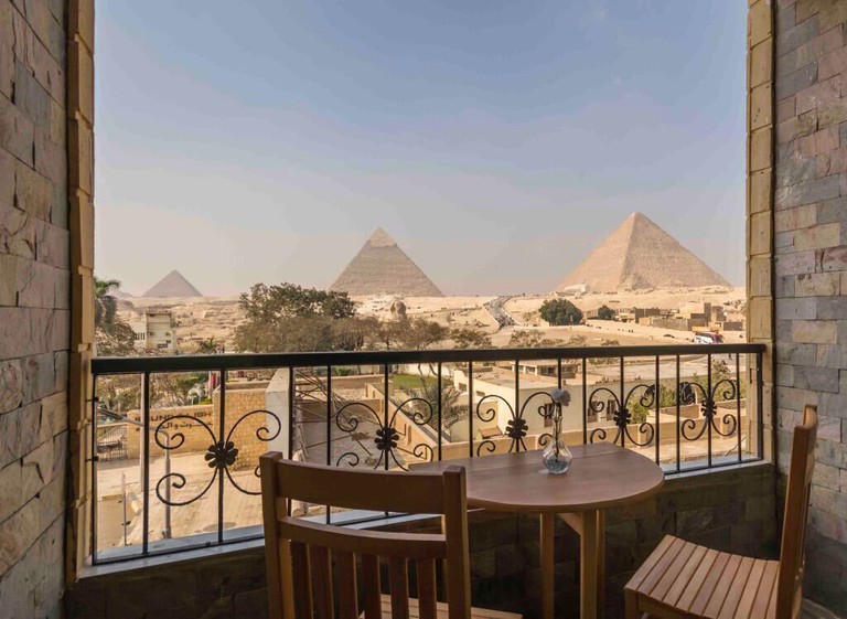 A view of Giza's iconic pyramids from a private guest balcony at the Pyramids View Inn