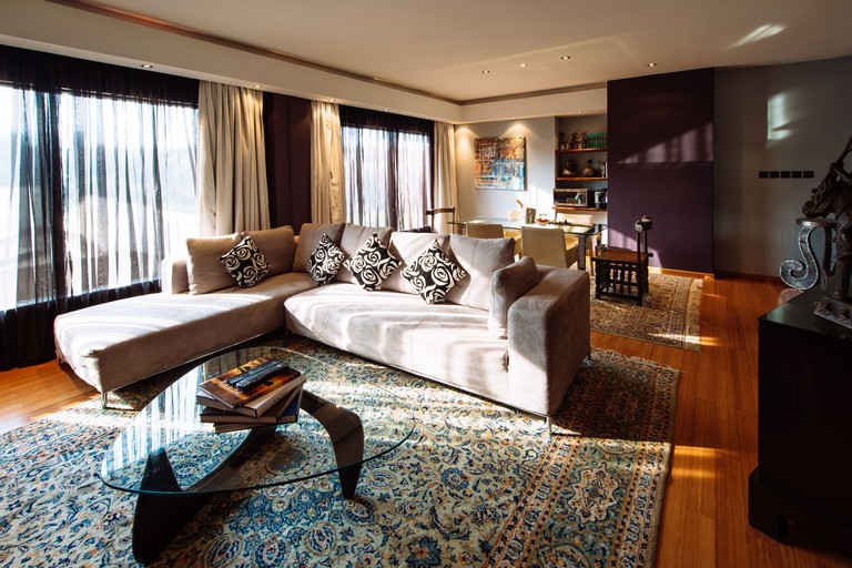 Living room at the Tribe Hotel, Nairobi, with a cream-coloured sofa and a glass coffee table