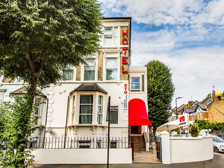 YO London exterior in classic townhouse style with red awning and trees
