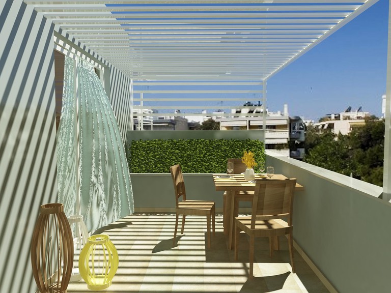 Hotel balcony with outside dining table, green walls and ornaments at Athens Lotus Hotel