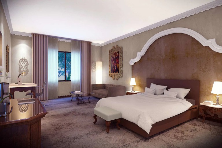 A grand one-bed guest room with local art on display at the Hilton Guatemala City